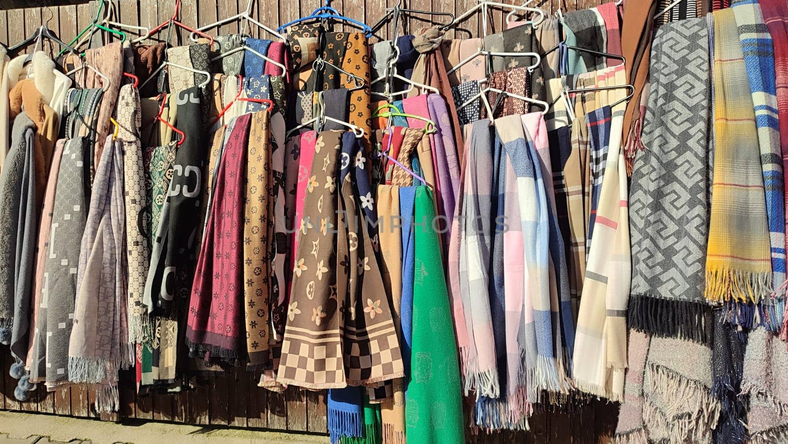Scarves hanging display clothing shop sale shopping centre culture colour . High quality photo