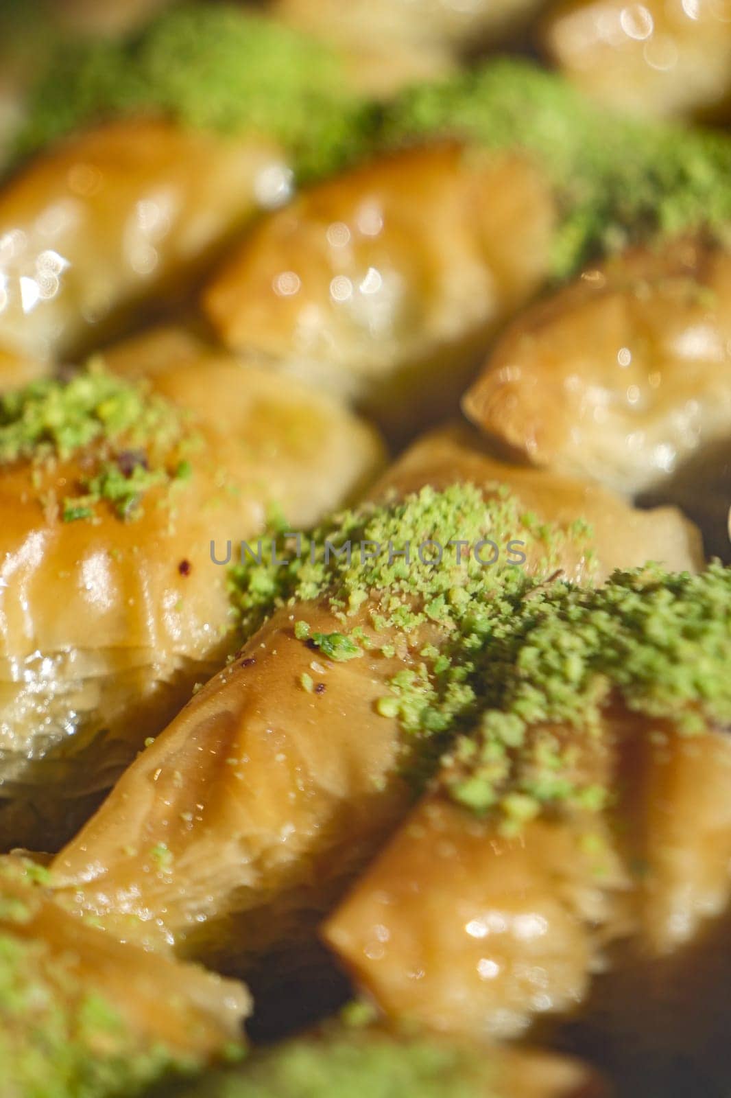 Freshly made pastry with nut filling and sweet syrup, garnished with green.