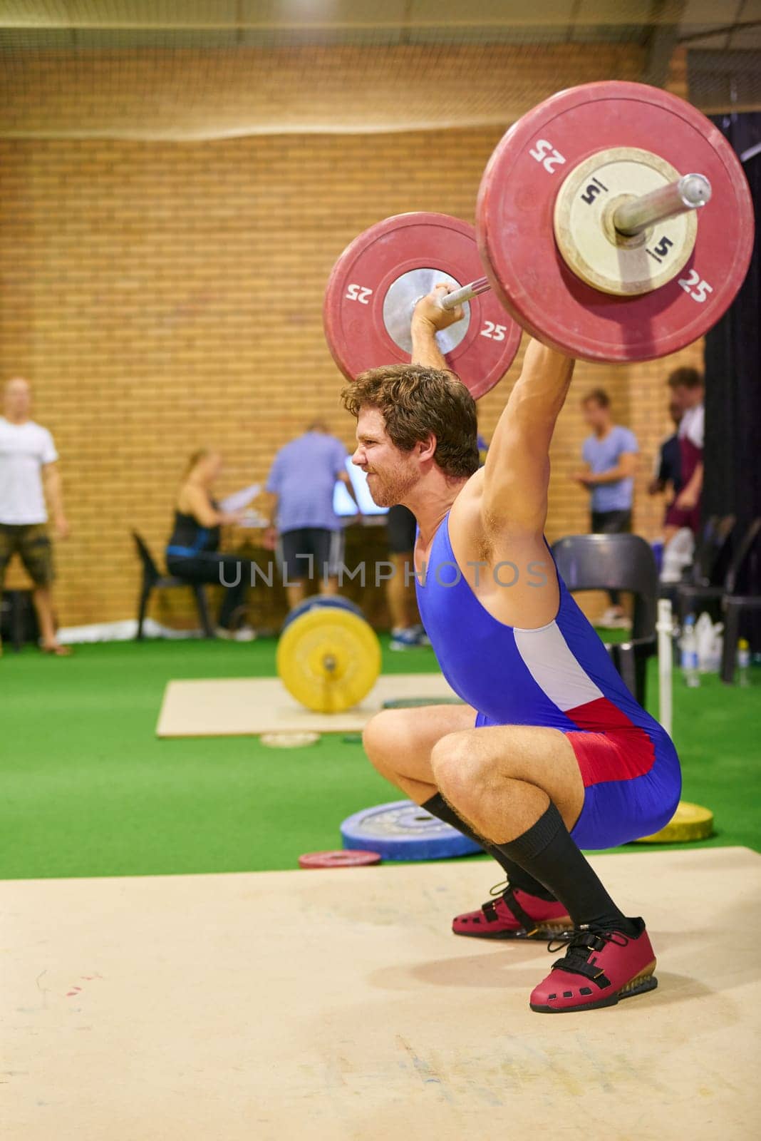 A weight lifter lifting weights during a competition