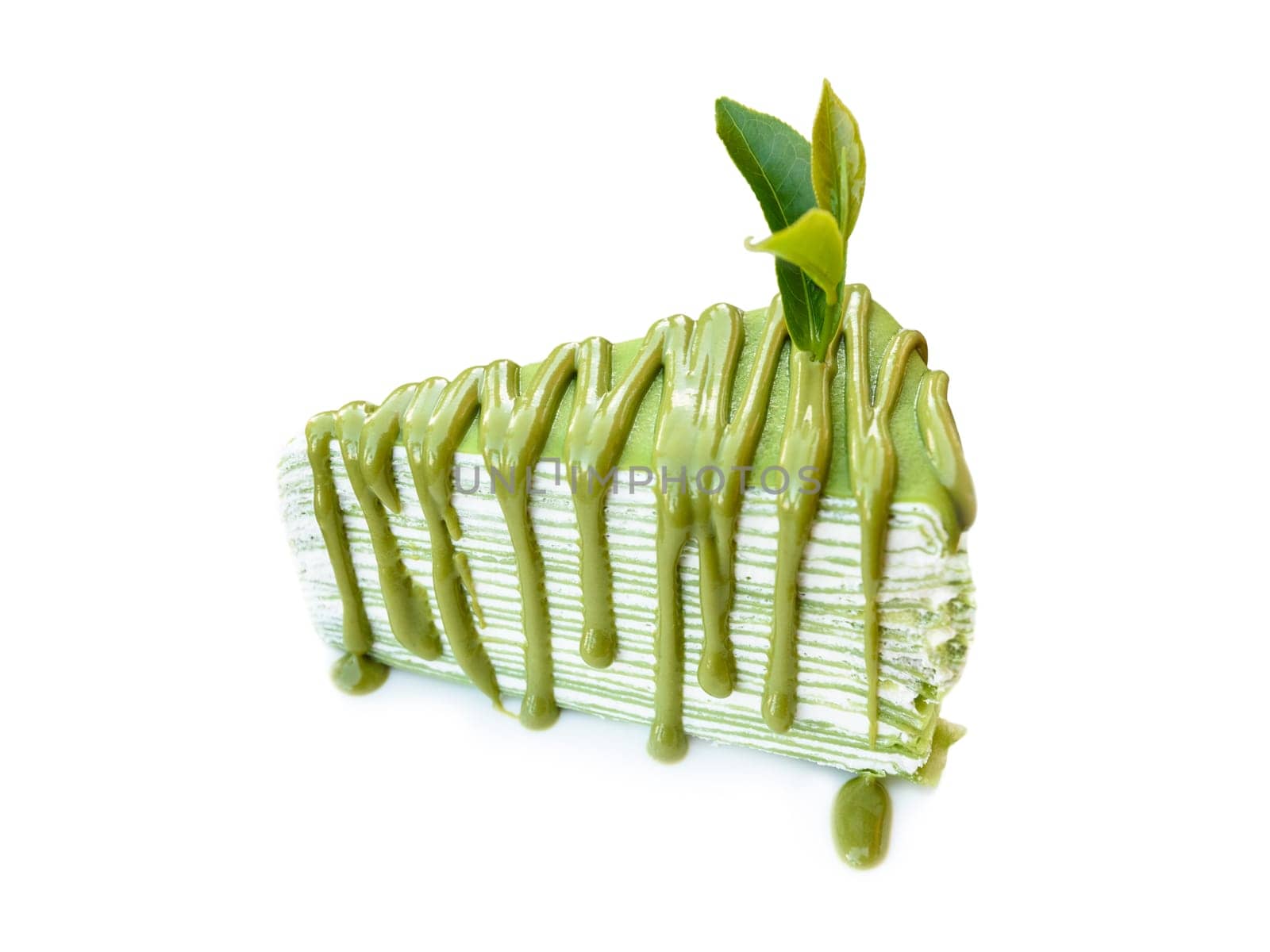 Closed up green tea leaf on cake with matcha green tea, isolated on white background