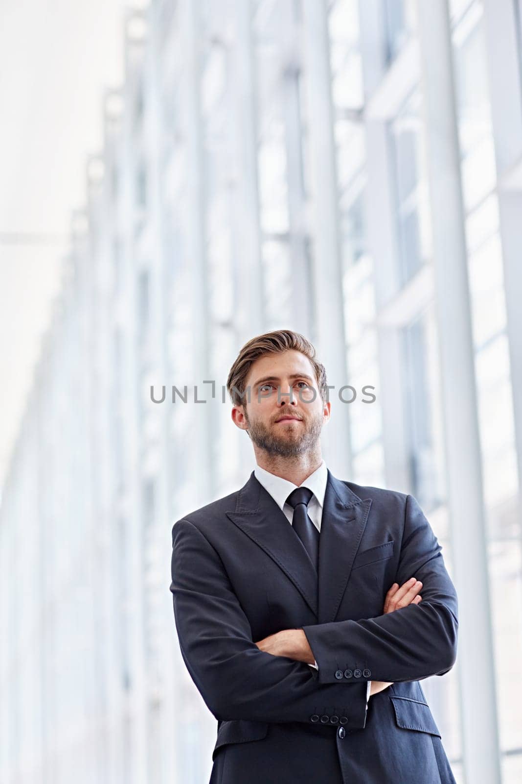 Low angle shot of a corporate executive in a modern architectural setting looking ahead confidently