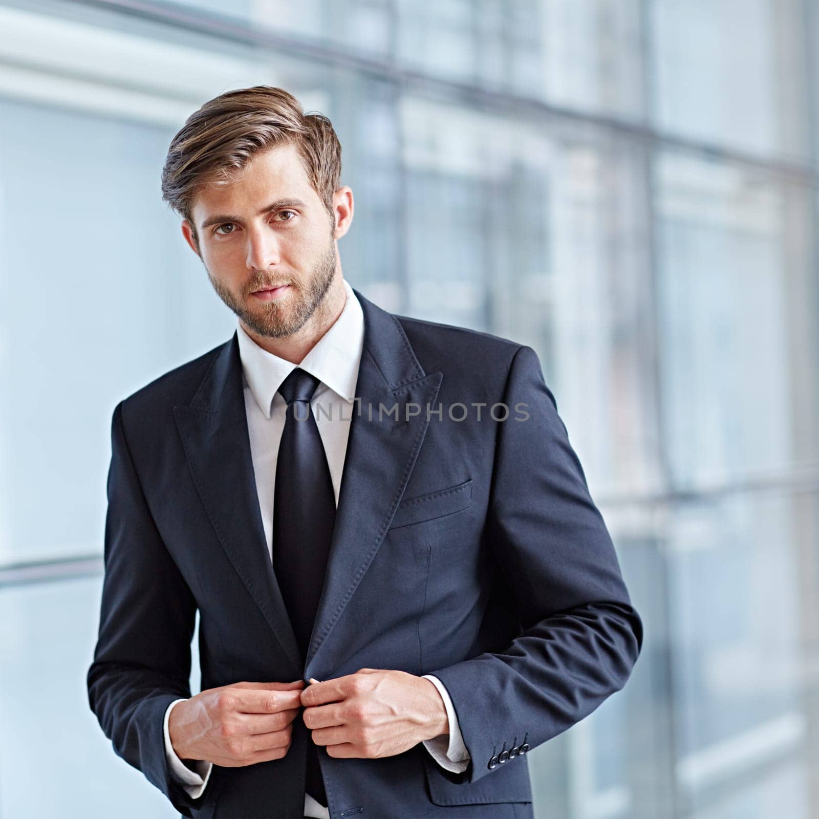 Portrait of a stylish corporate executive looking seriously at the camera