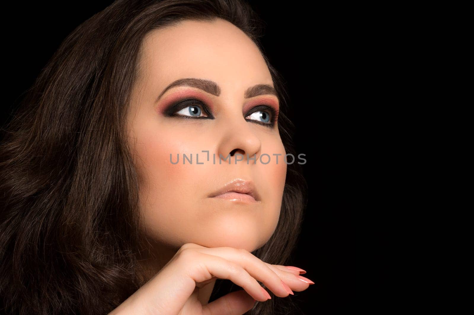 Beauty portrait about woman with blue eyes and light pink make-up.