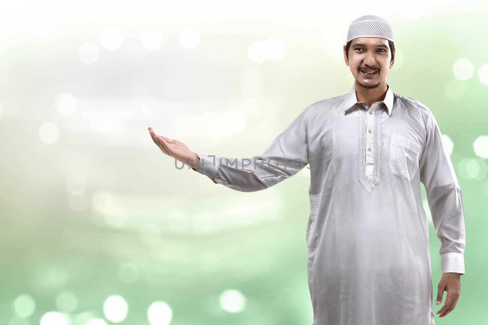 Image of muslim handsome man show something