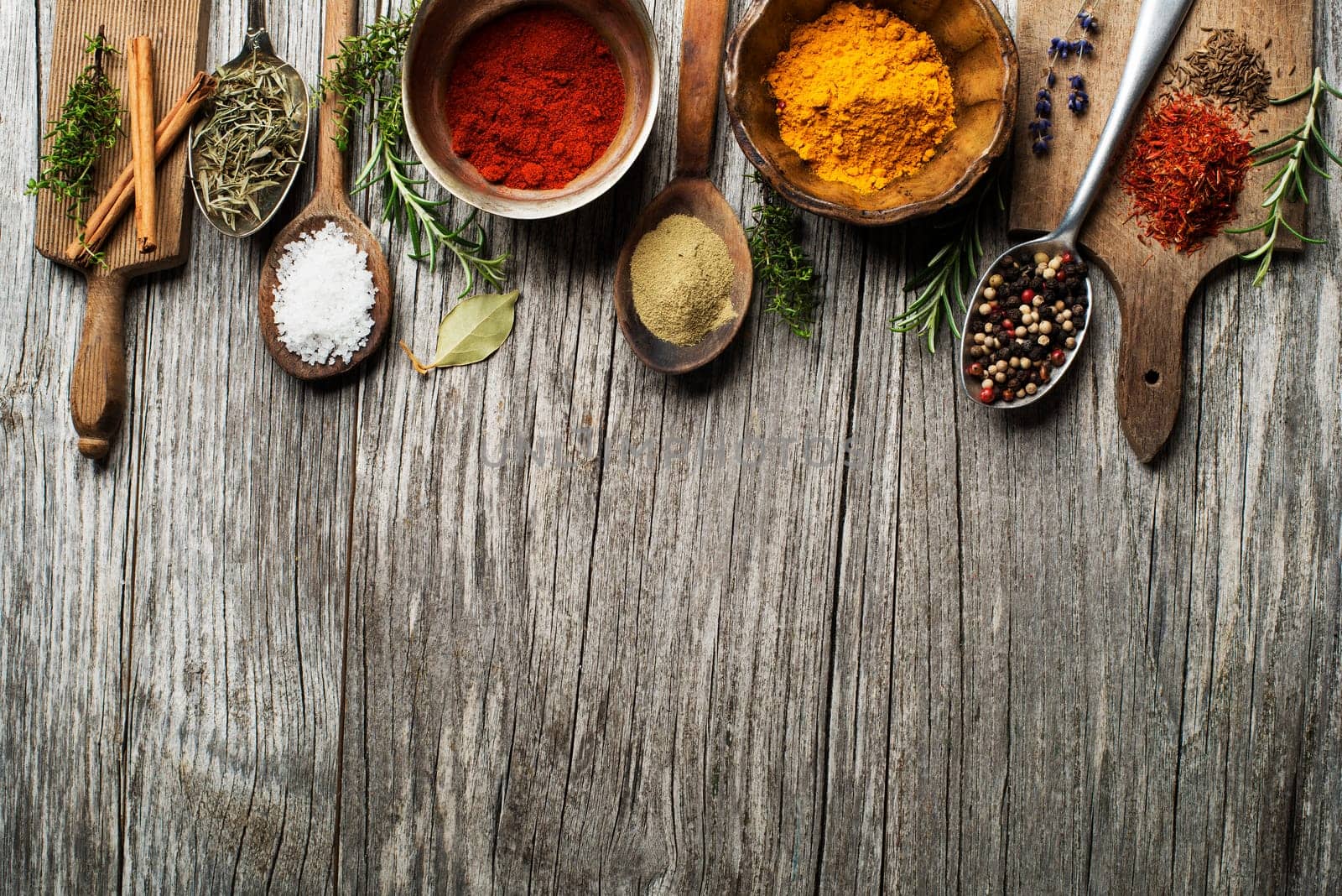 Fresh herbs and spices on a wooden background