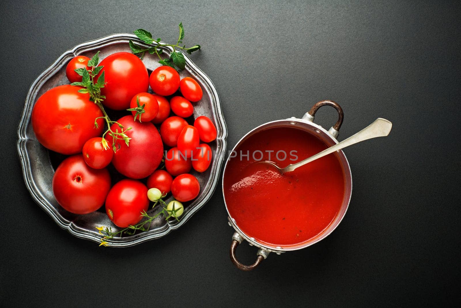 Fresh tomatoes for sauce and soup on black background