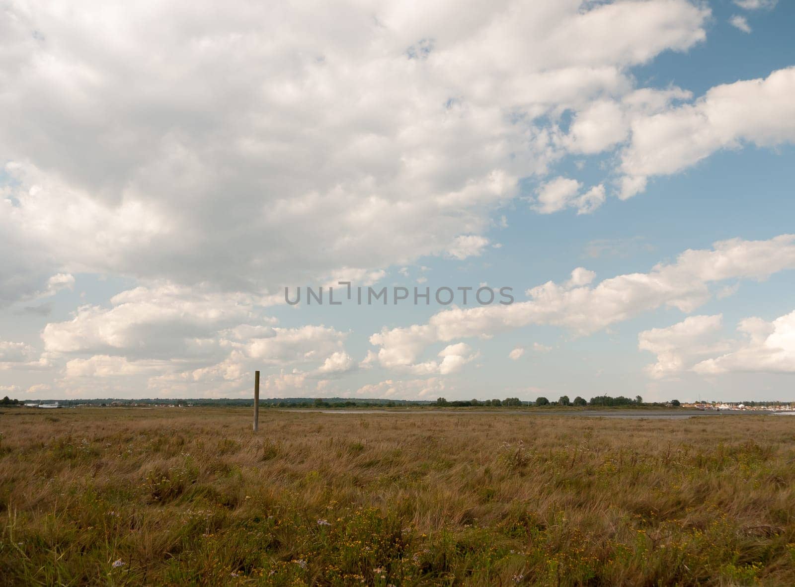 a flat countryside scene in essex maldon on the black water cloudy blue sky Essex  England  UK