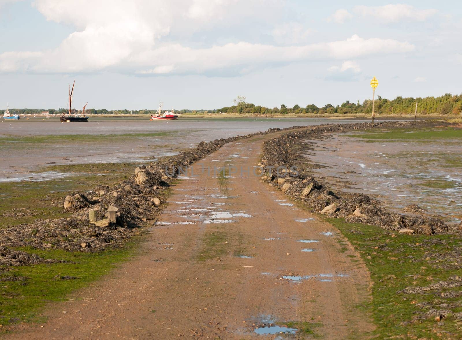 road leading onto island with tide out black water Maldon Essex  England  UK