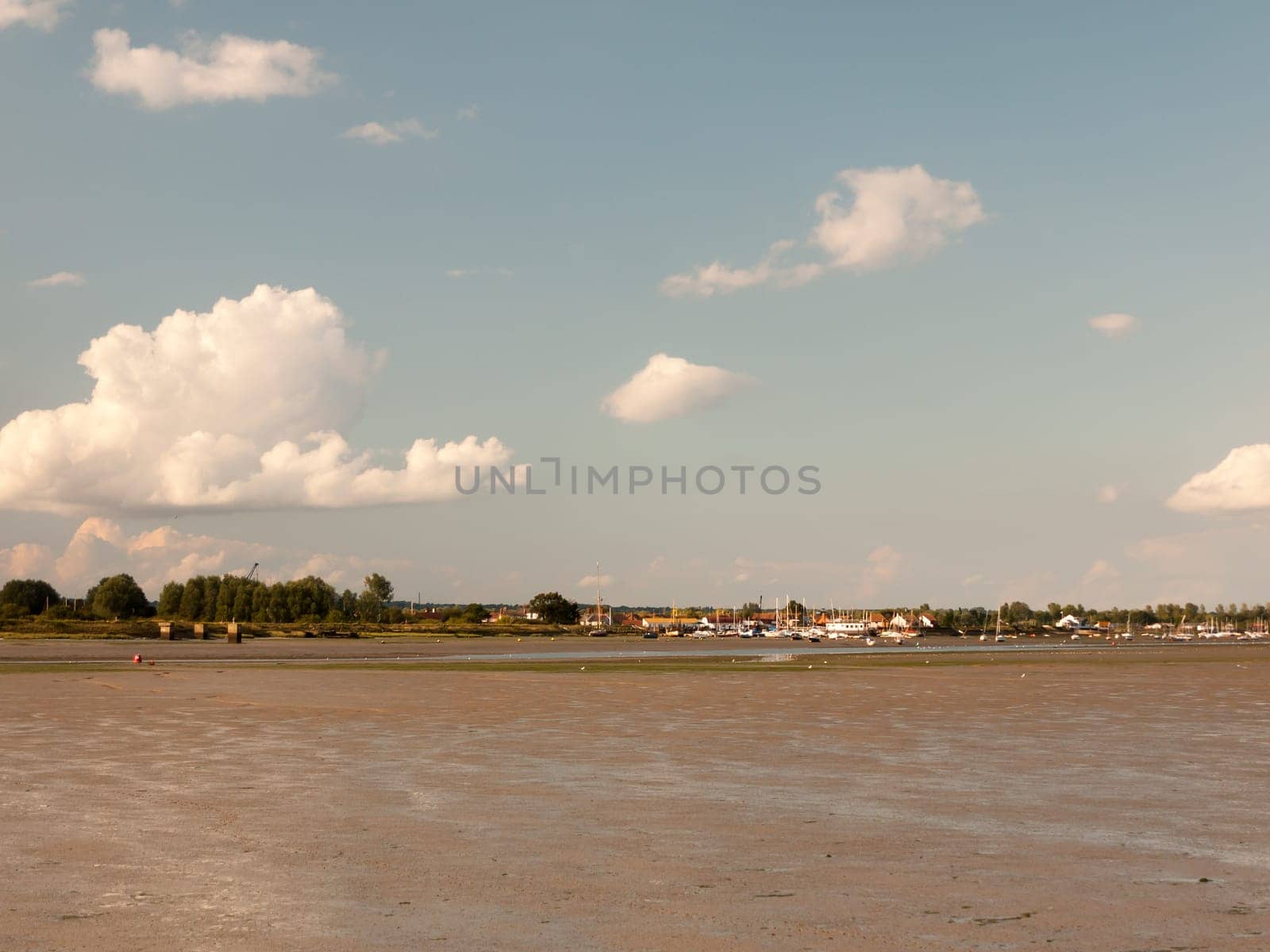 landscape view of maldon docks boats moored across from mudflats with tide out sunny Essex  England  UK