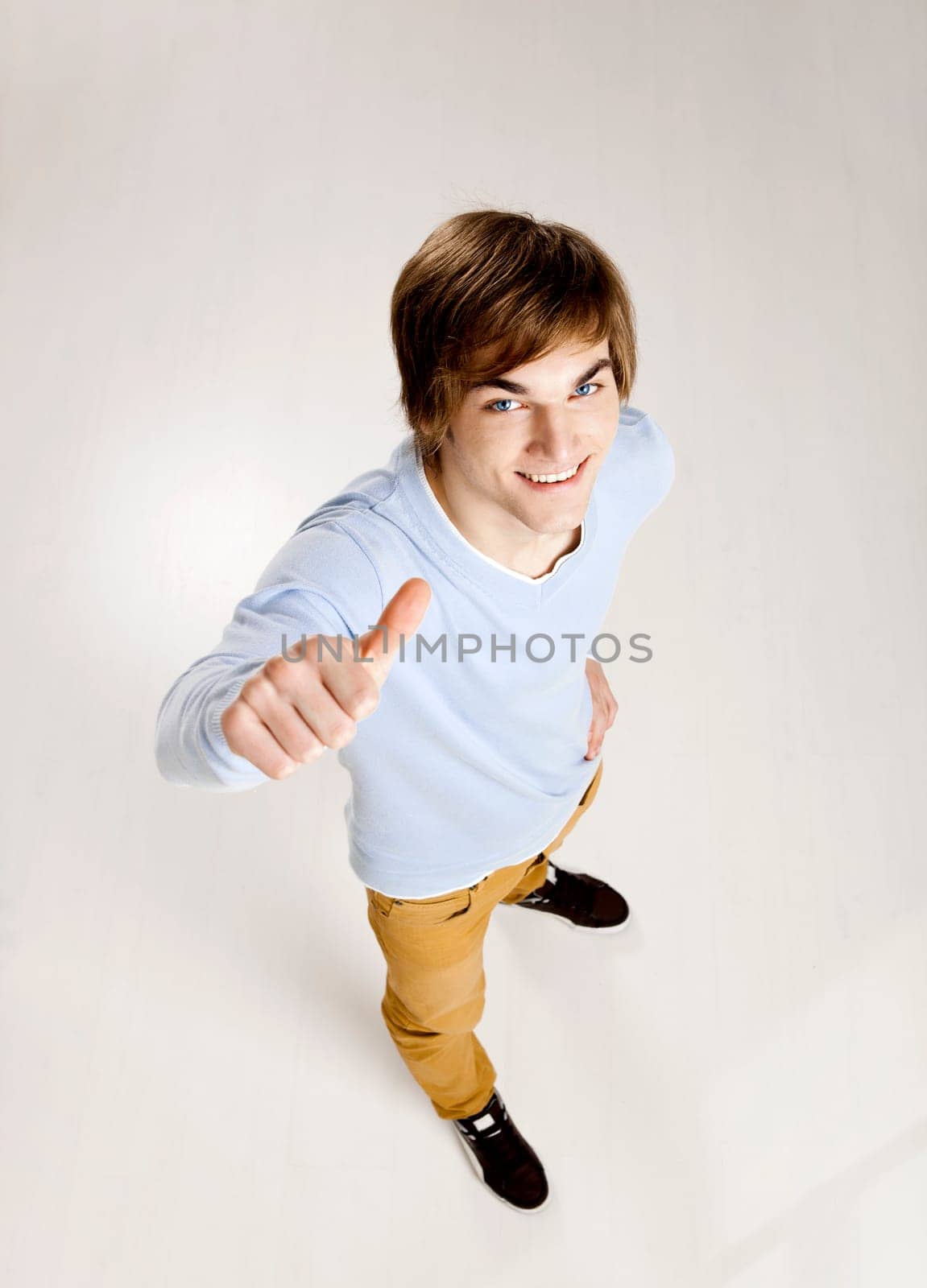 Portrait of a handsome young man looking up and laughing