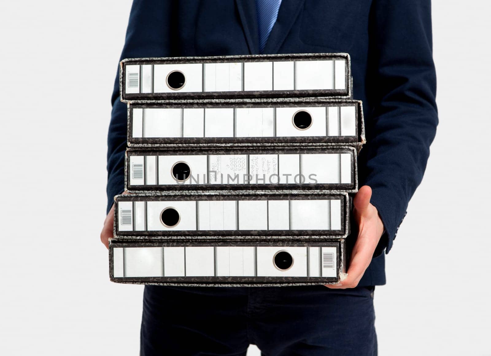 Young business man carrying a bunch of folders