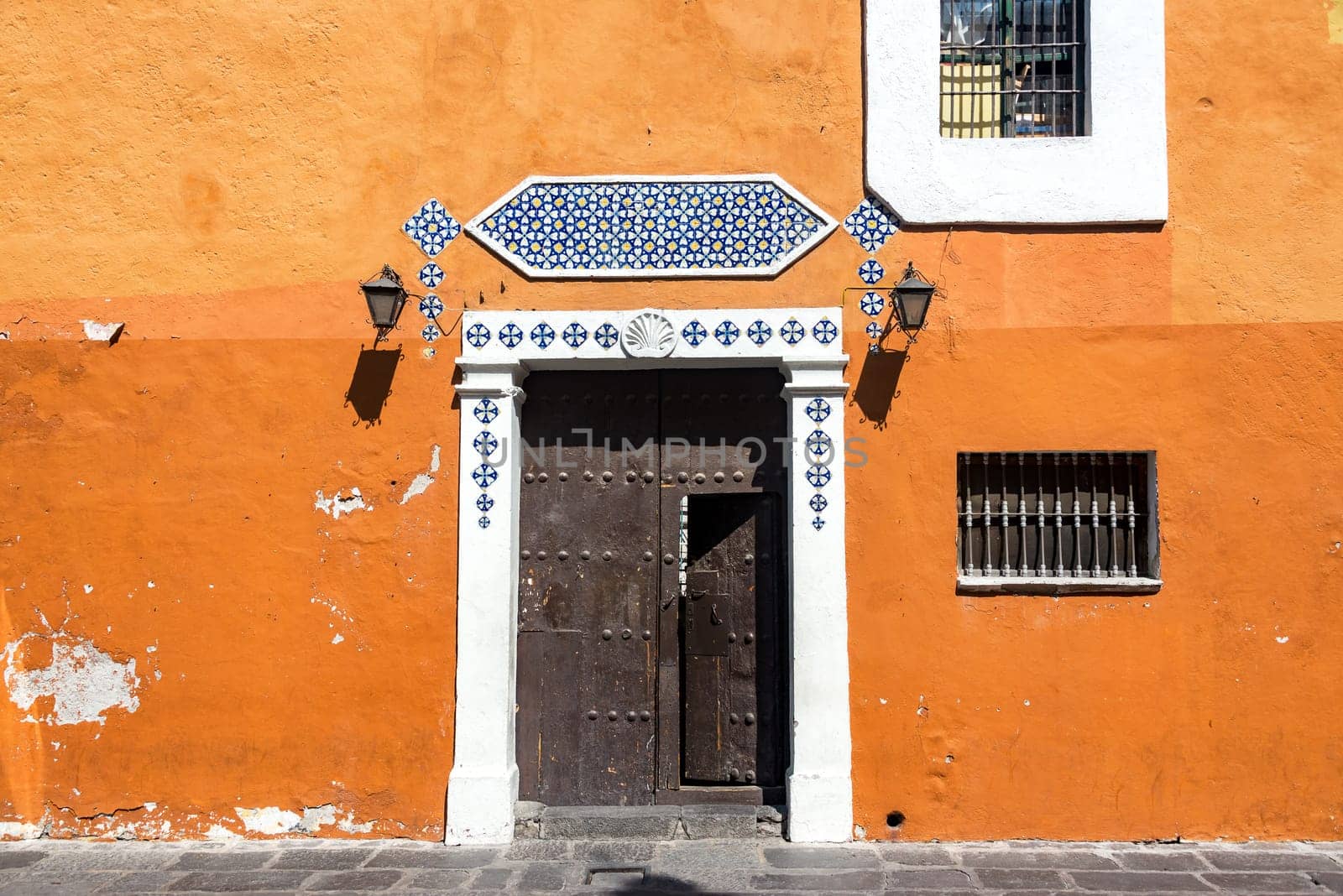 Historic orange colonial building in the center of Puebla, Mexico