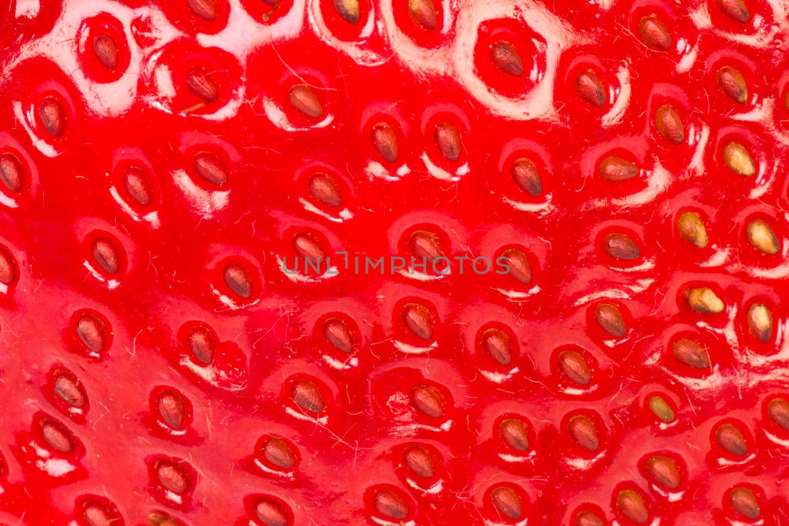 Extreme close-up about strawberry surface as texture background.