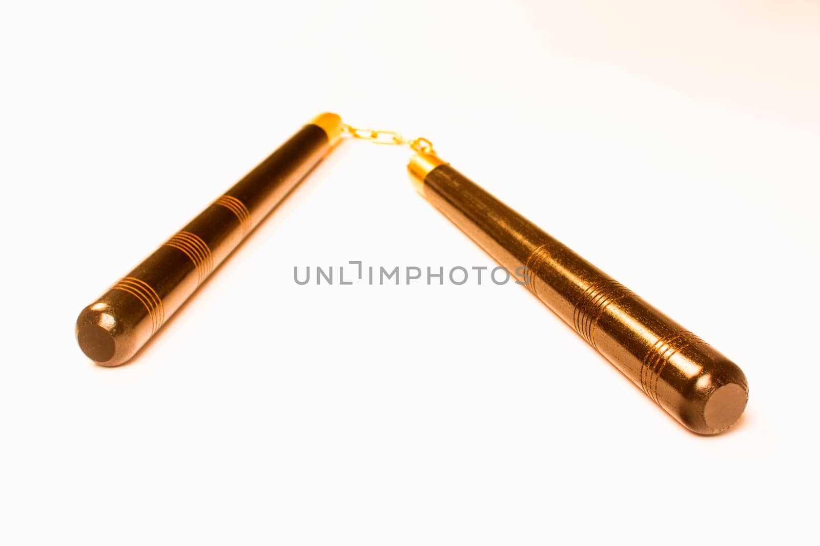 Bronze nunchaku, the Asian weapon is isolated on white background.