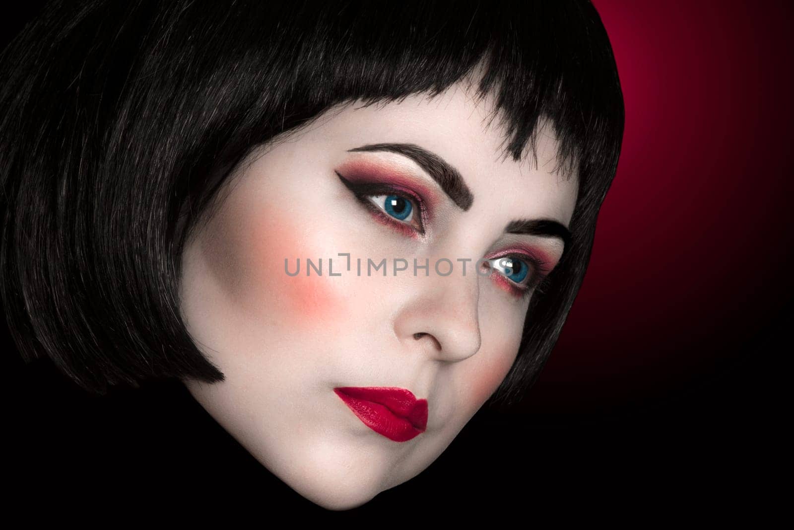 Beauty portrait about woman with white face and red make-up.