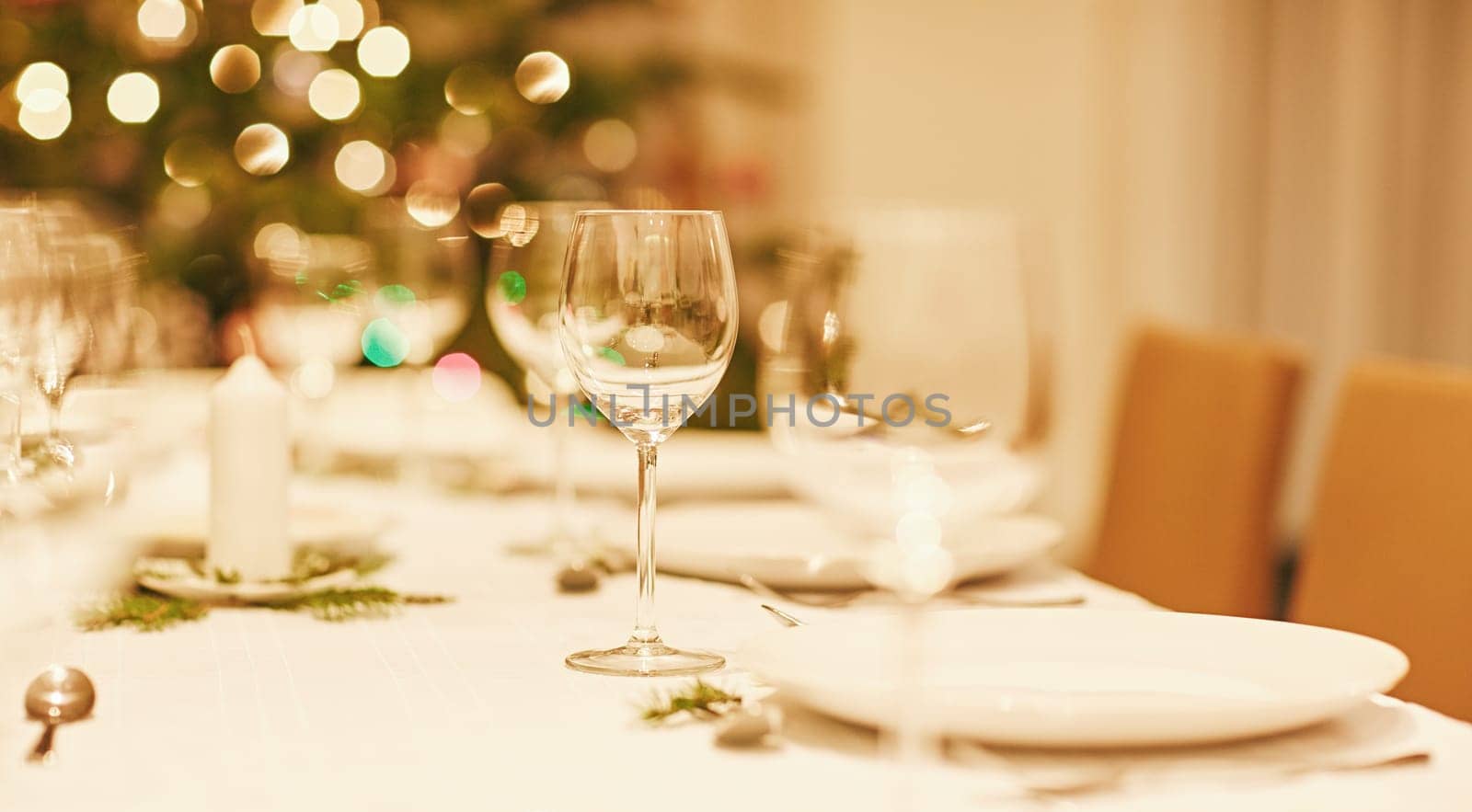 Closeup of a glass on a christmas table with bokeh in the background