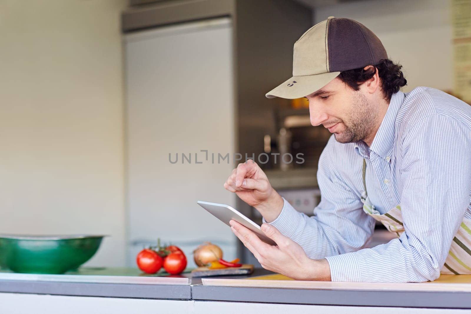 Male entrepeneur in his takeaway food kitchen using his phone