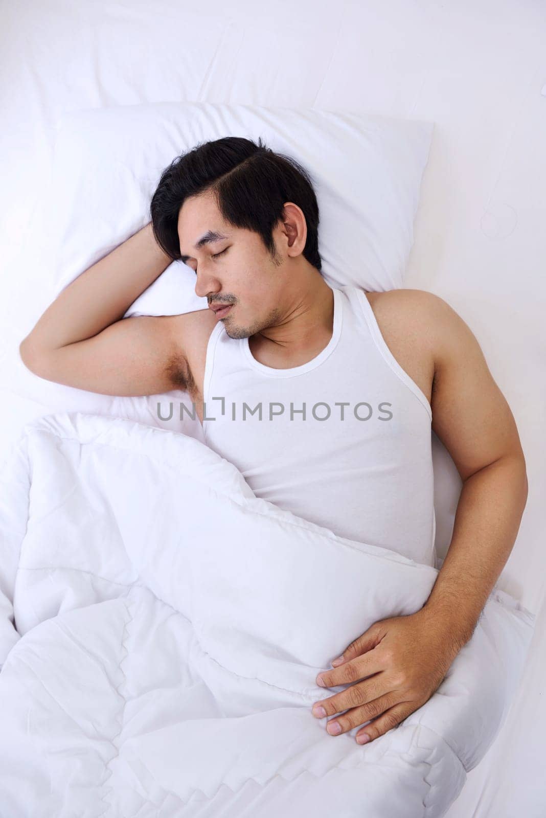 Handsome asian man sleep tightly in his bedroom