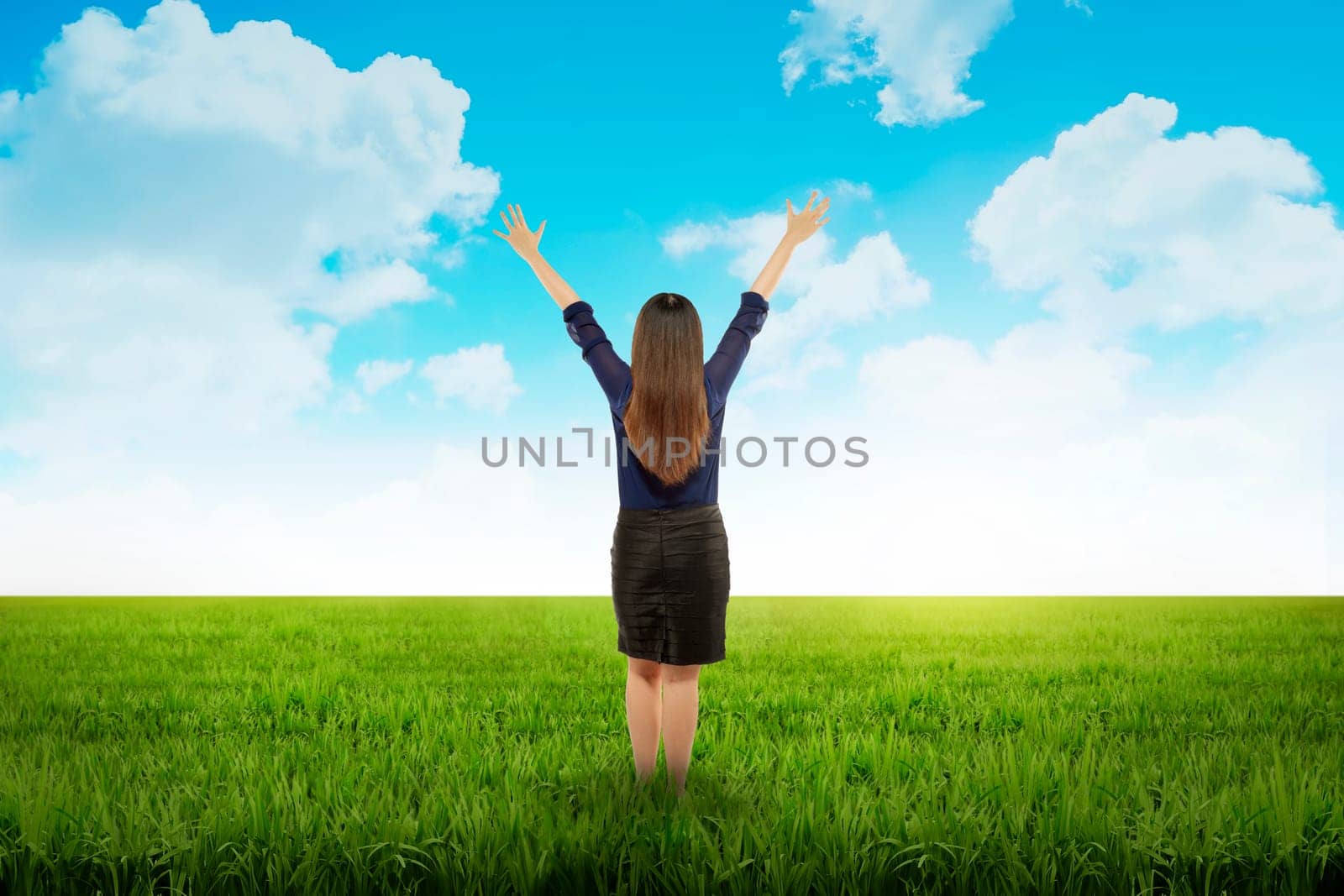 Business woman feeling happy on the meadow at summer time