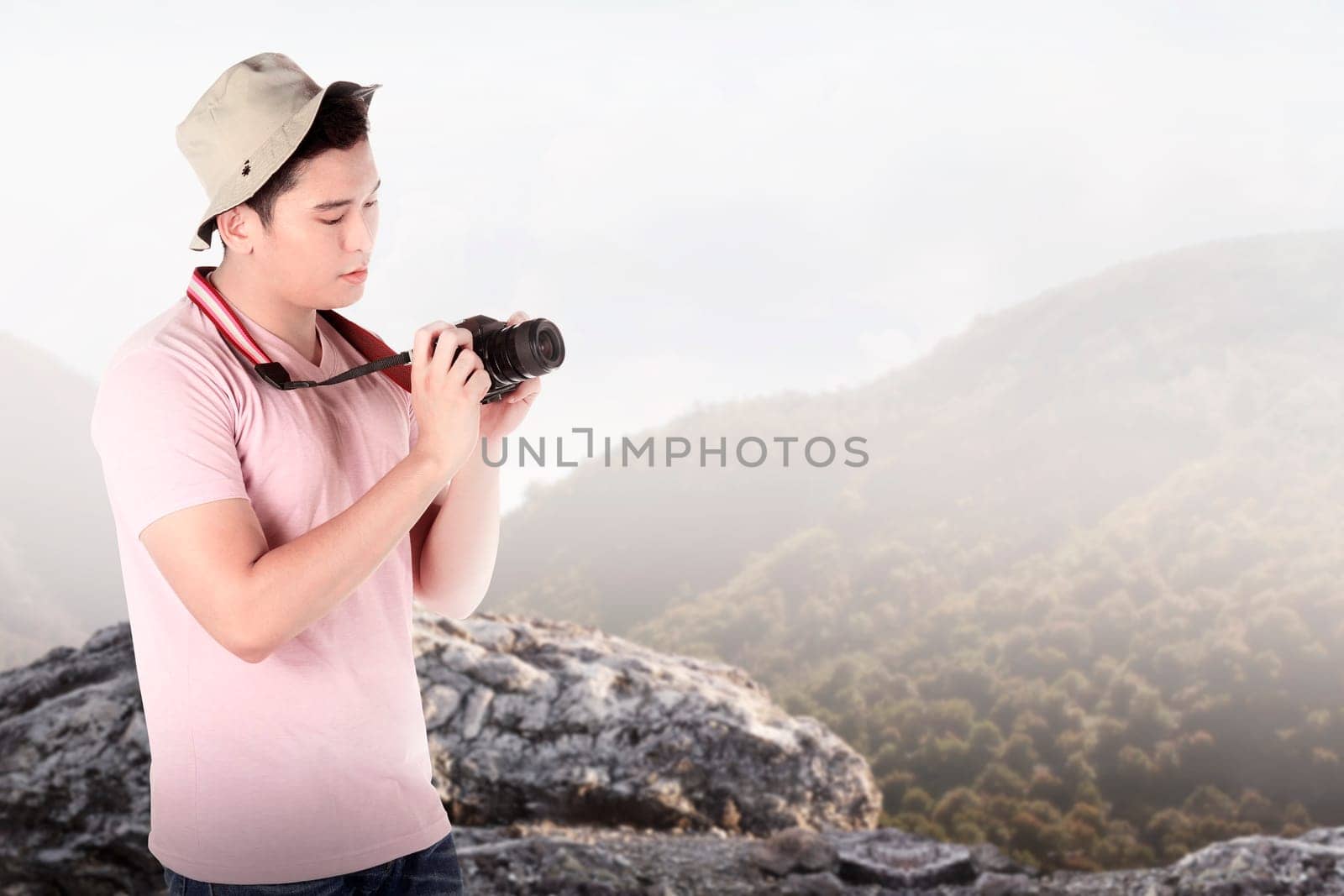 A tourist taking image with camera on mountain landscape