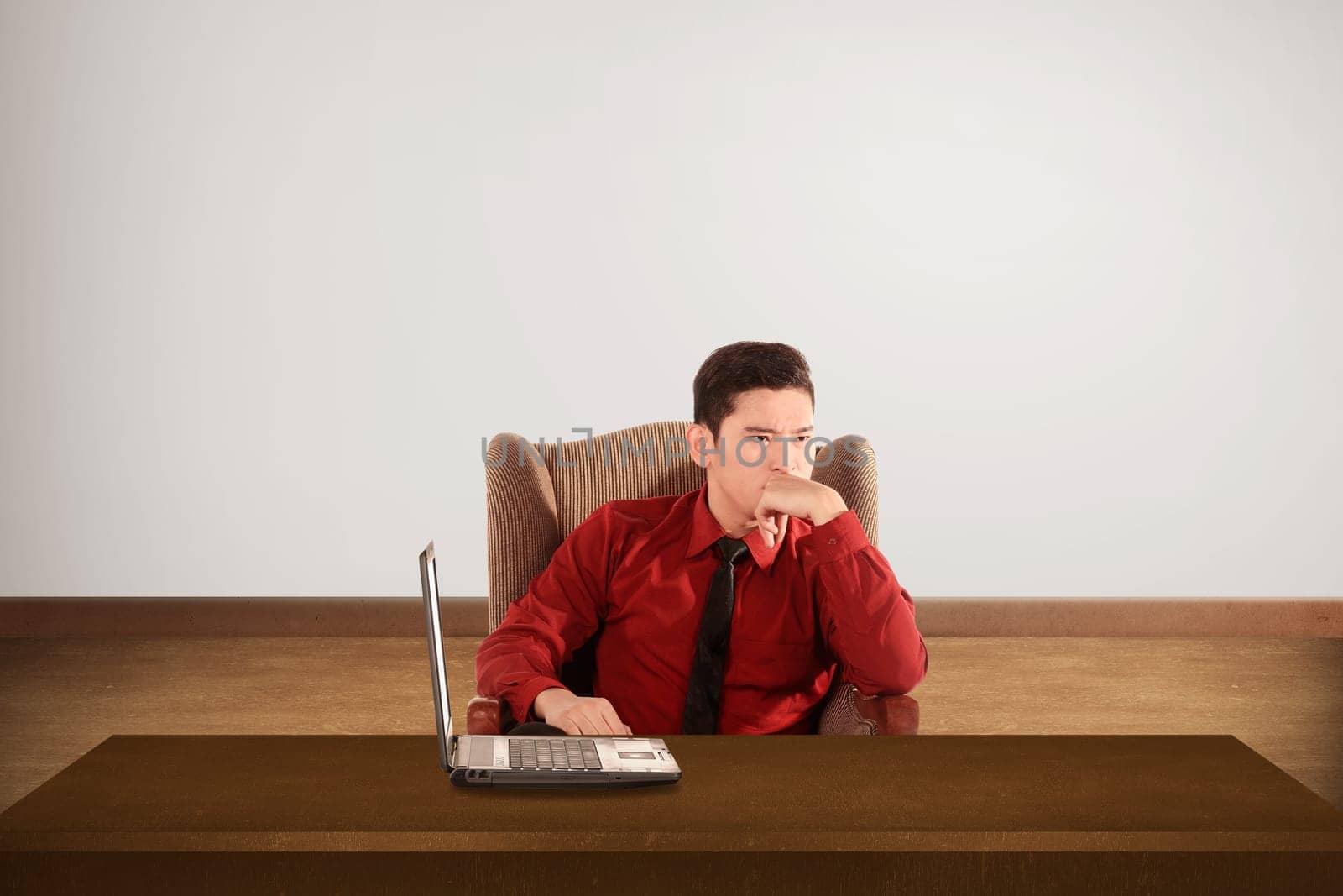 Business man thinking something with laptop on the desk