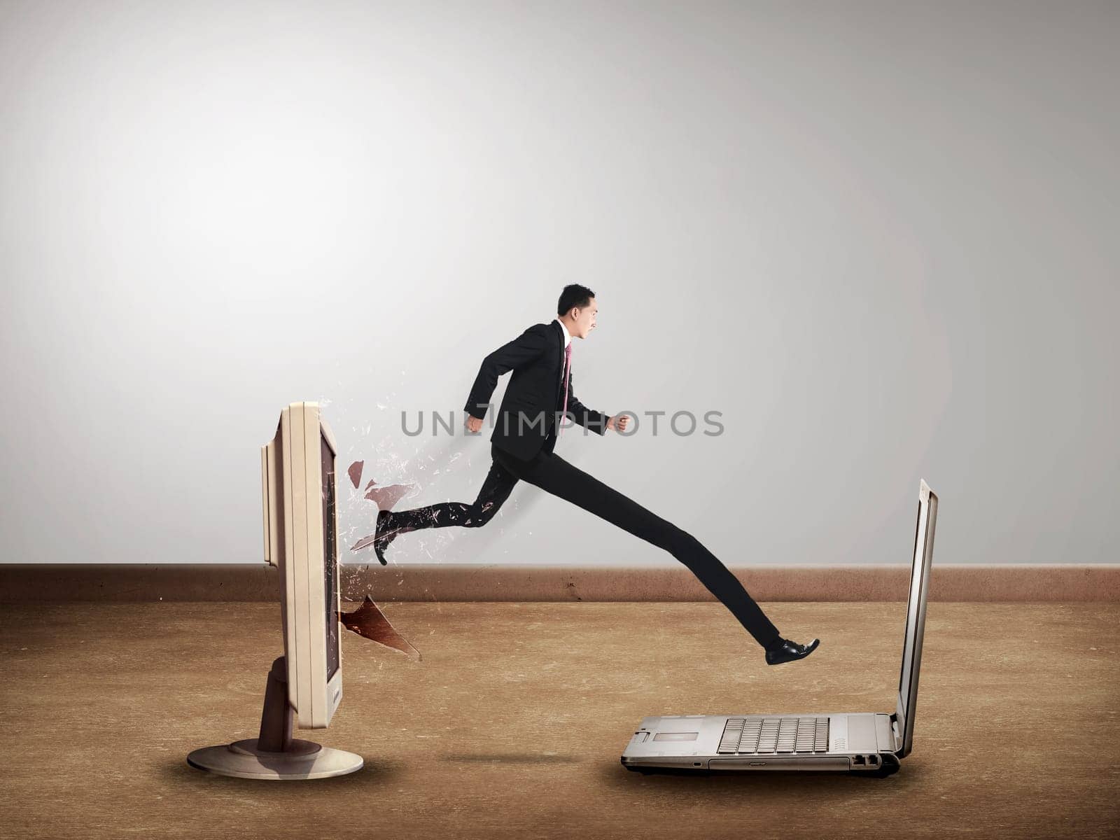 Business man with long leg out from computer desktop to laptop. Gadget switch concept