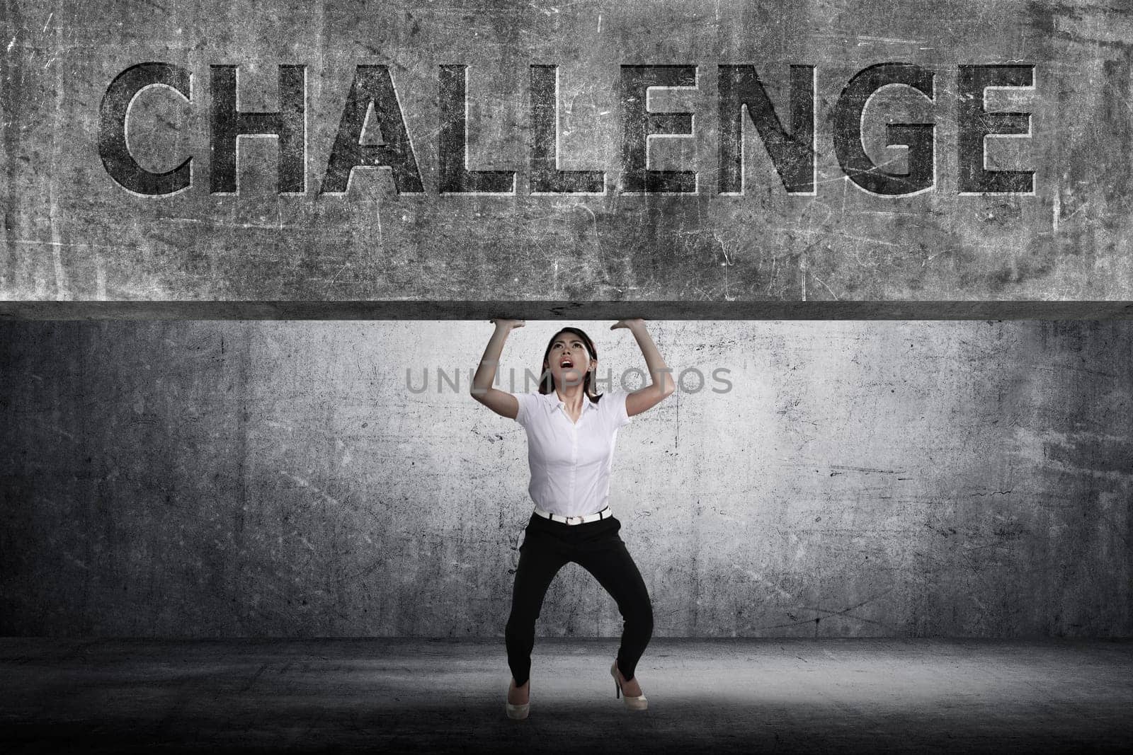 Asian business woman lift heavy block. Business challenge concept