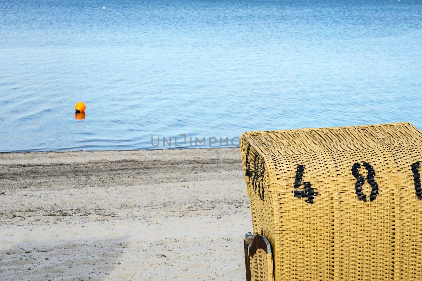 European Beach wicker chairs are placed decoratively on the beach for summer guests in the sun