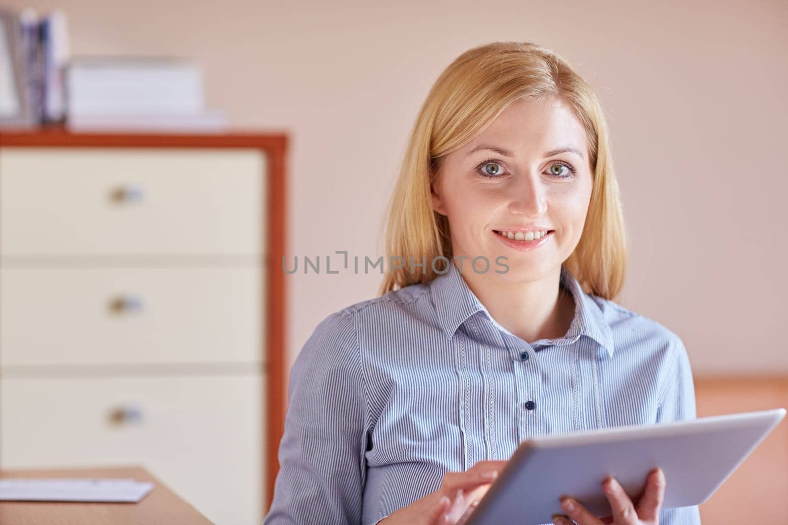 A young businesswoman working on her digital tablet