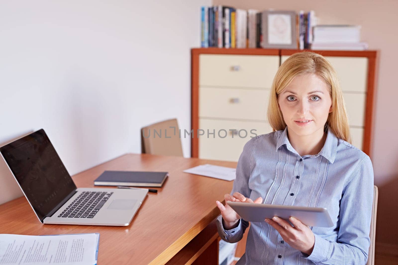 A young businesswoman working on her digital tablet