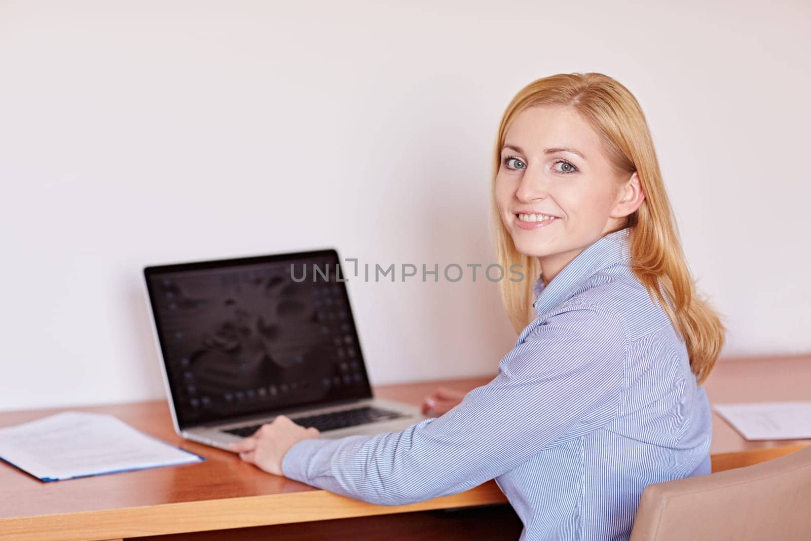 A young businesswoman working on her laptop in her office