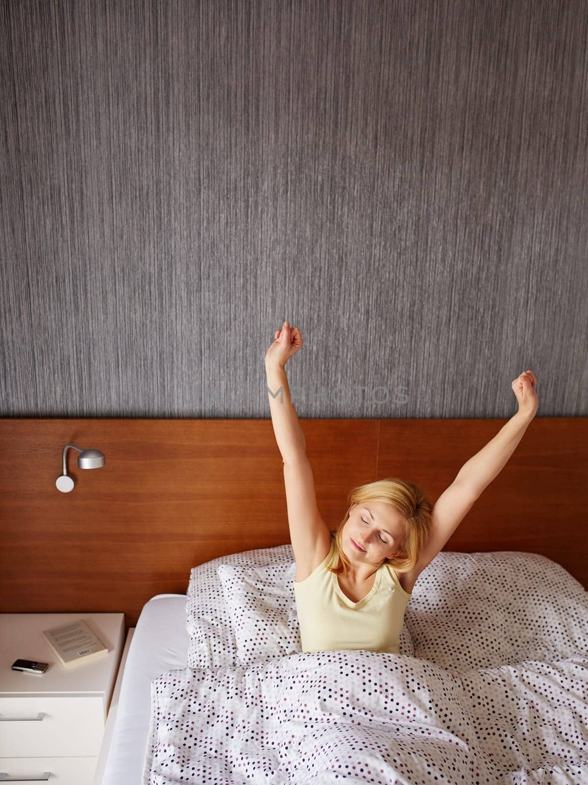 A young woman stretching out after waking