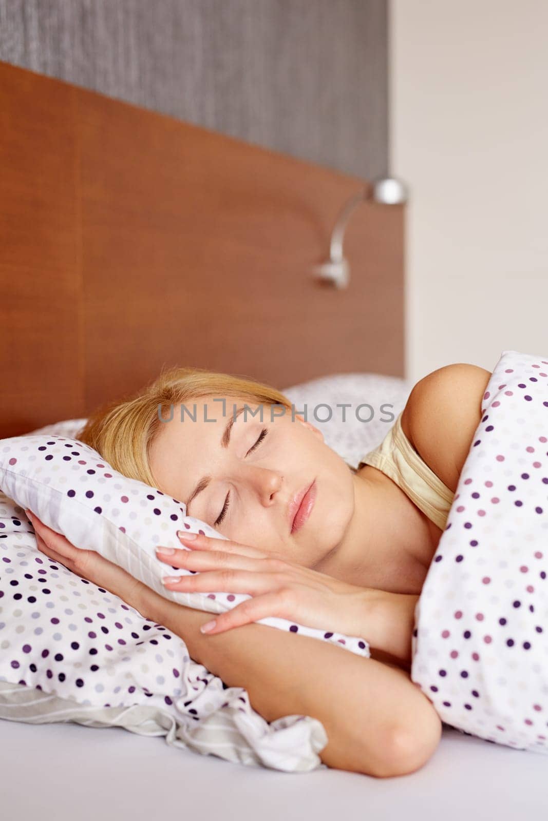 A young woman asleep in her bed