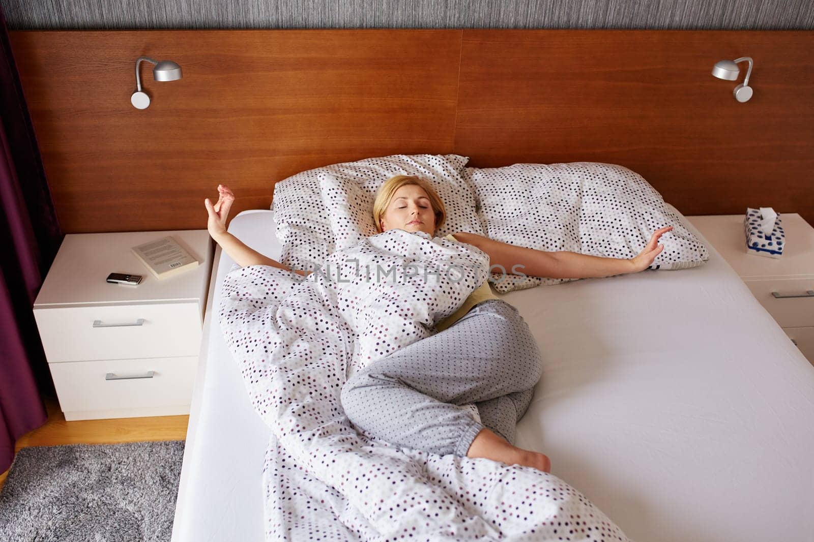 A young woman stretching out after waking