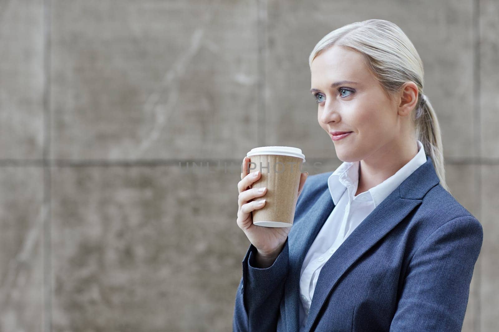 A young businesswoman holding a cup of coffee