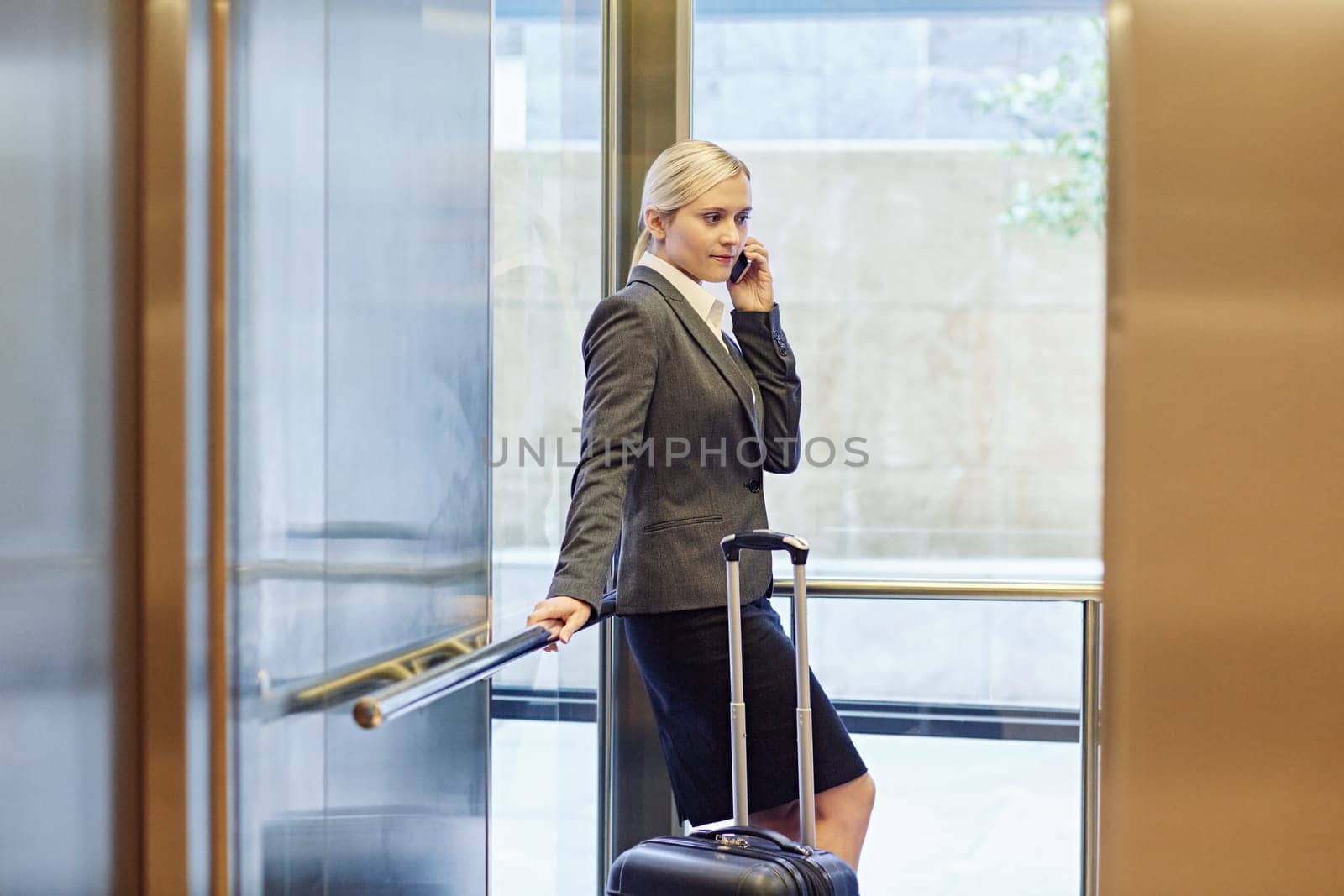 Businesswoman talking on the phone in elevator