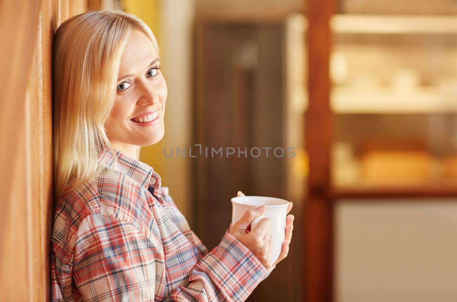 A young woman drinking coffee at home