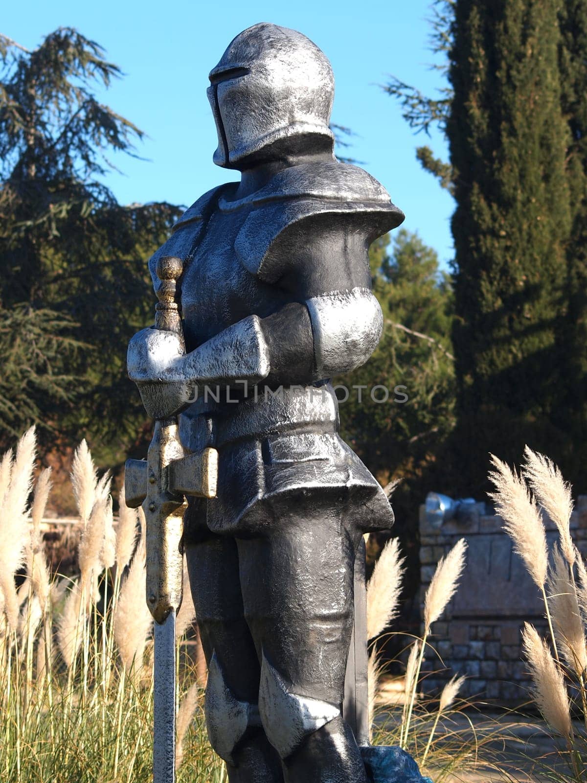 statue of Knight Swordsman in Full Armour standing in front of  museum