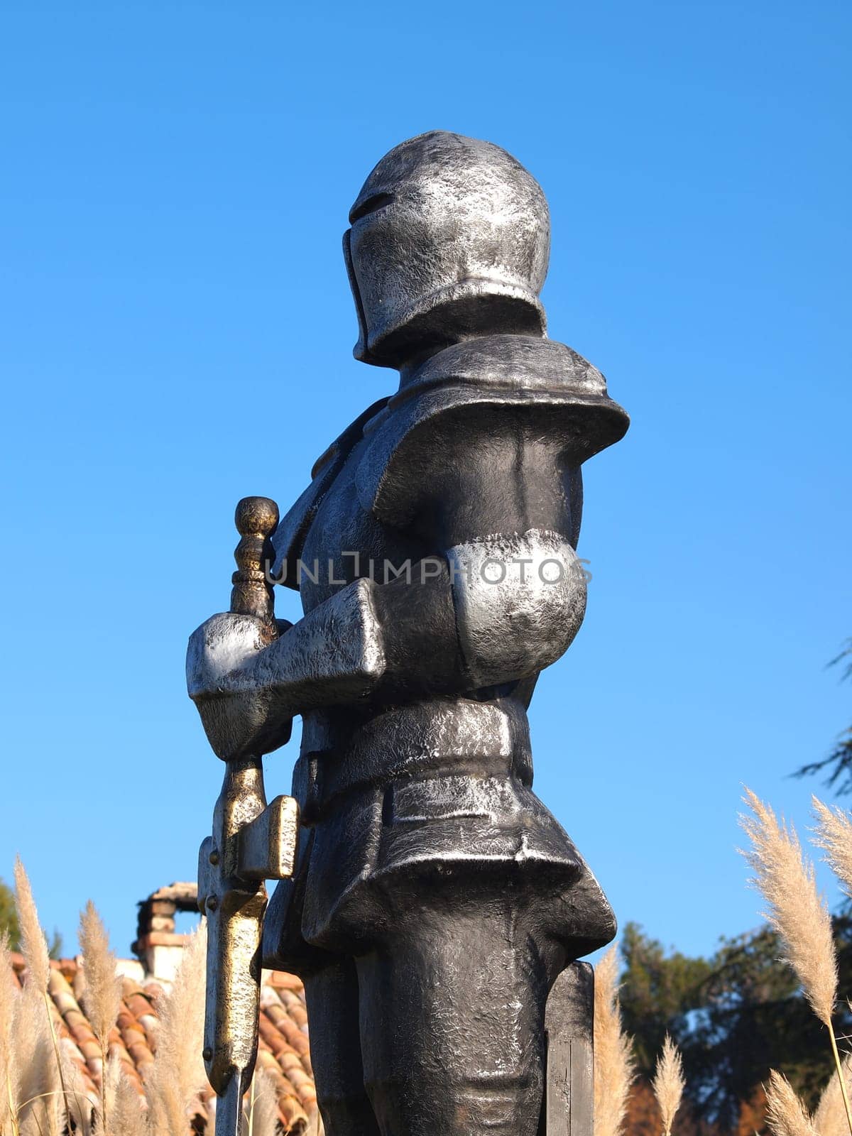 statue of Knight Swordsman in Full Armour standing in front of  museum
