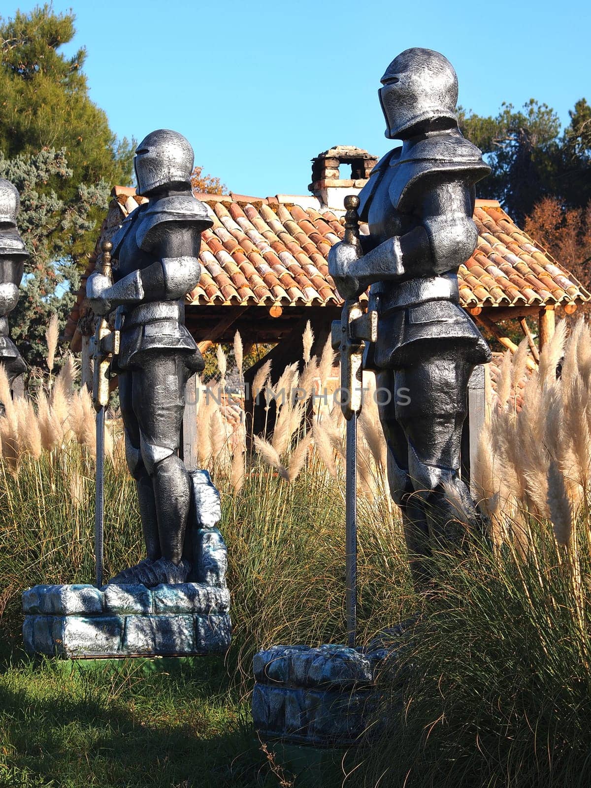 statue of Knight Swordsman in Full Armour standing in front of  museum