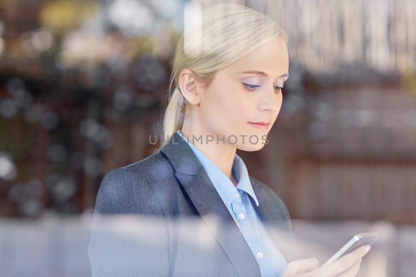 A young businesswoman typing on her cellphone