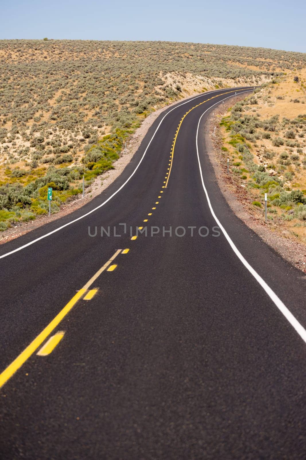 Two Lane yellow line curve around the bend