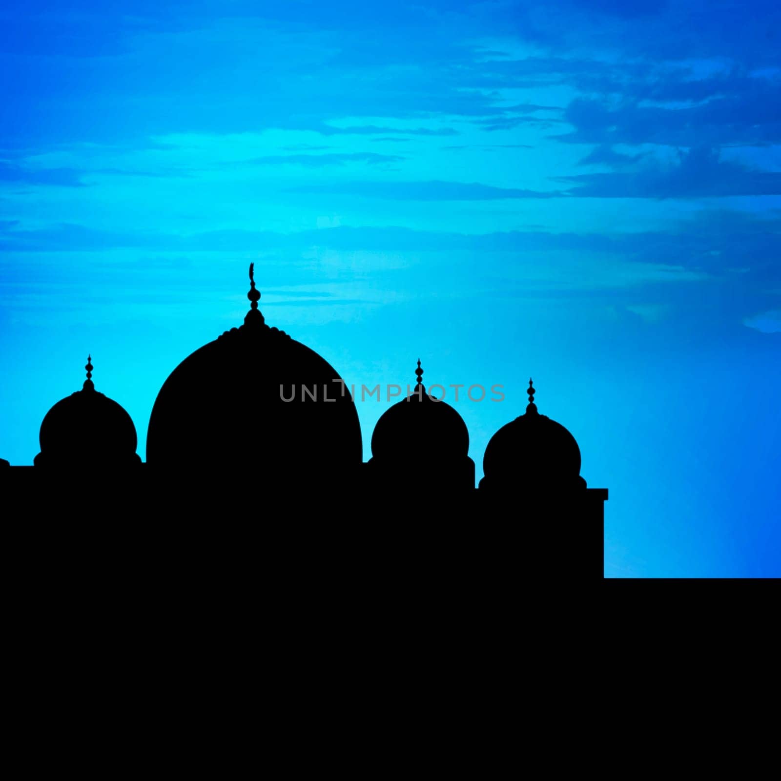Silhouette of a mosque in sunset with blue sky background