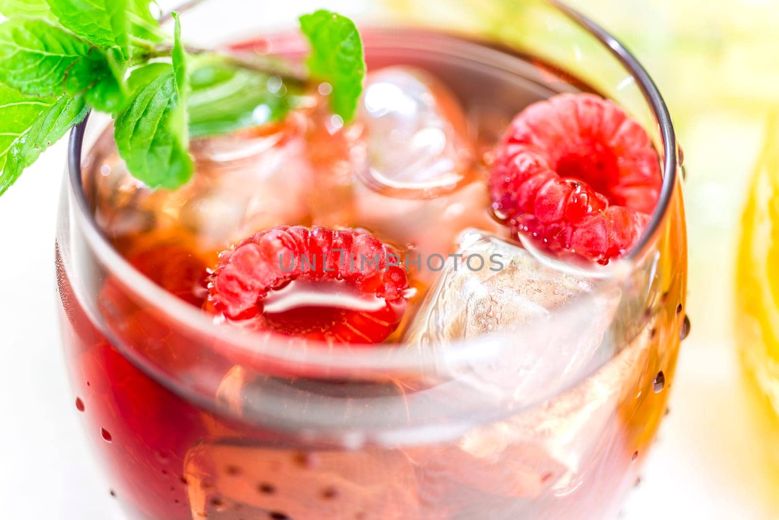 Iced tea with fruits in bulbous low glasses