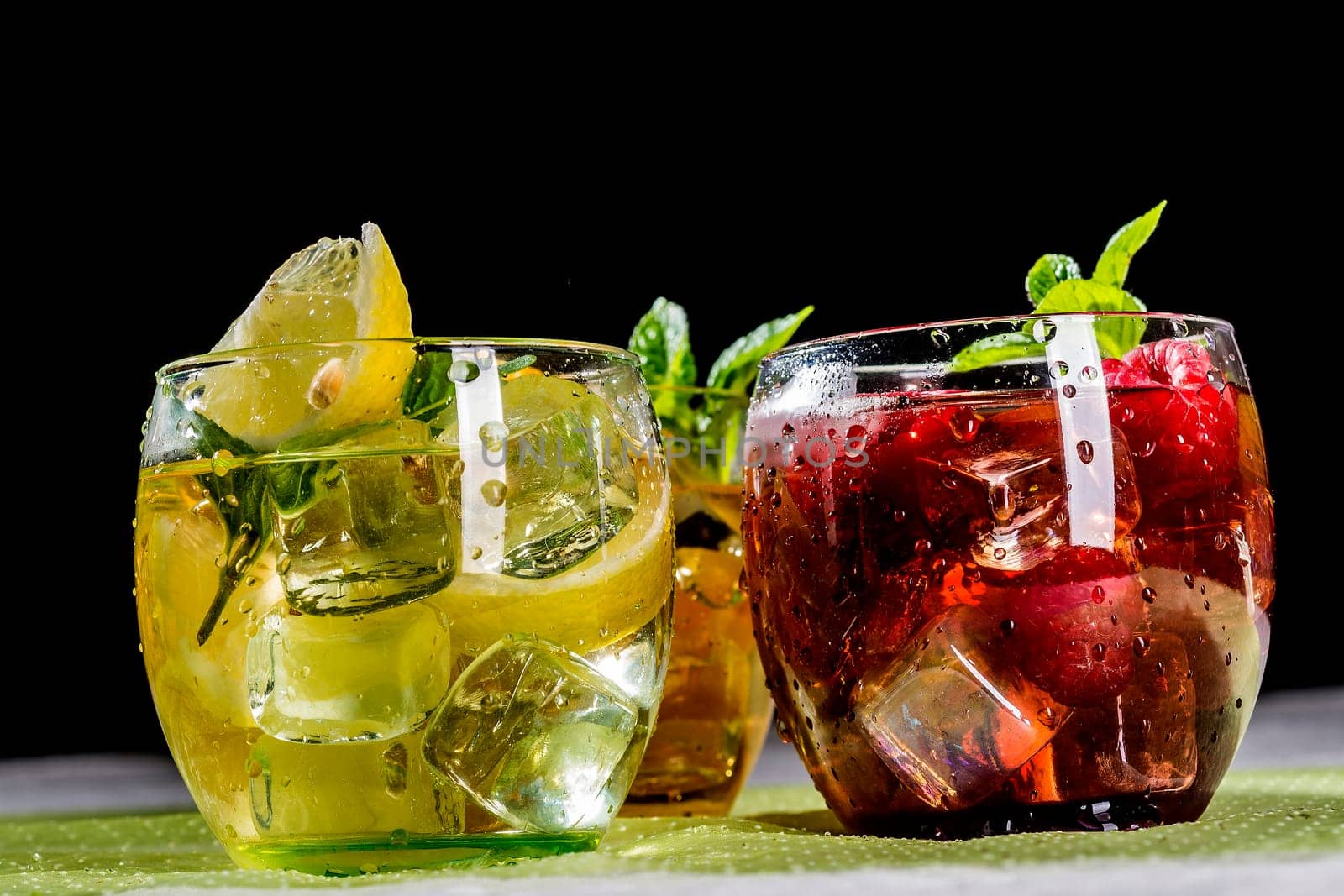 Iced tea with fruits in bulbous low glasses