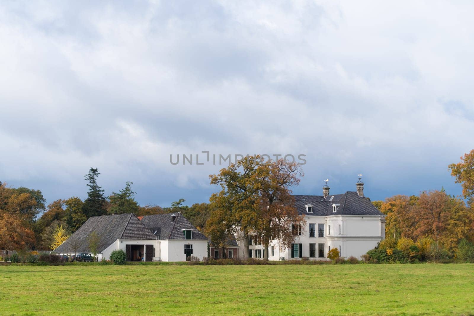 DENEKAMP, NETHERLANDS - NOVEMBER 2, 2016: Singraven mansion with neoclassical frontage in a rural surrounding