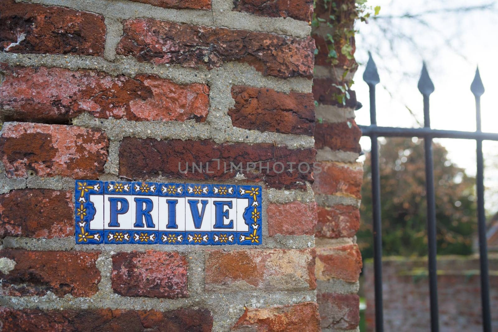 Prive (private in english) sign on a stone brick wall
