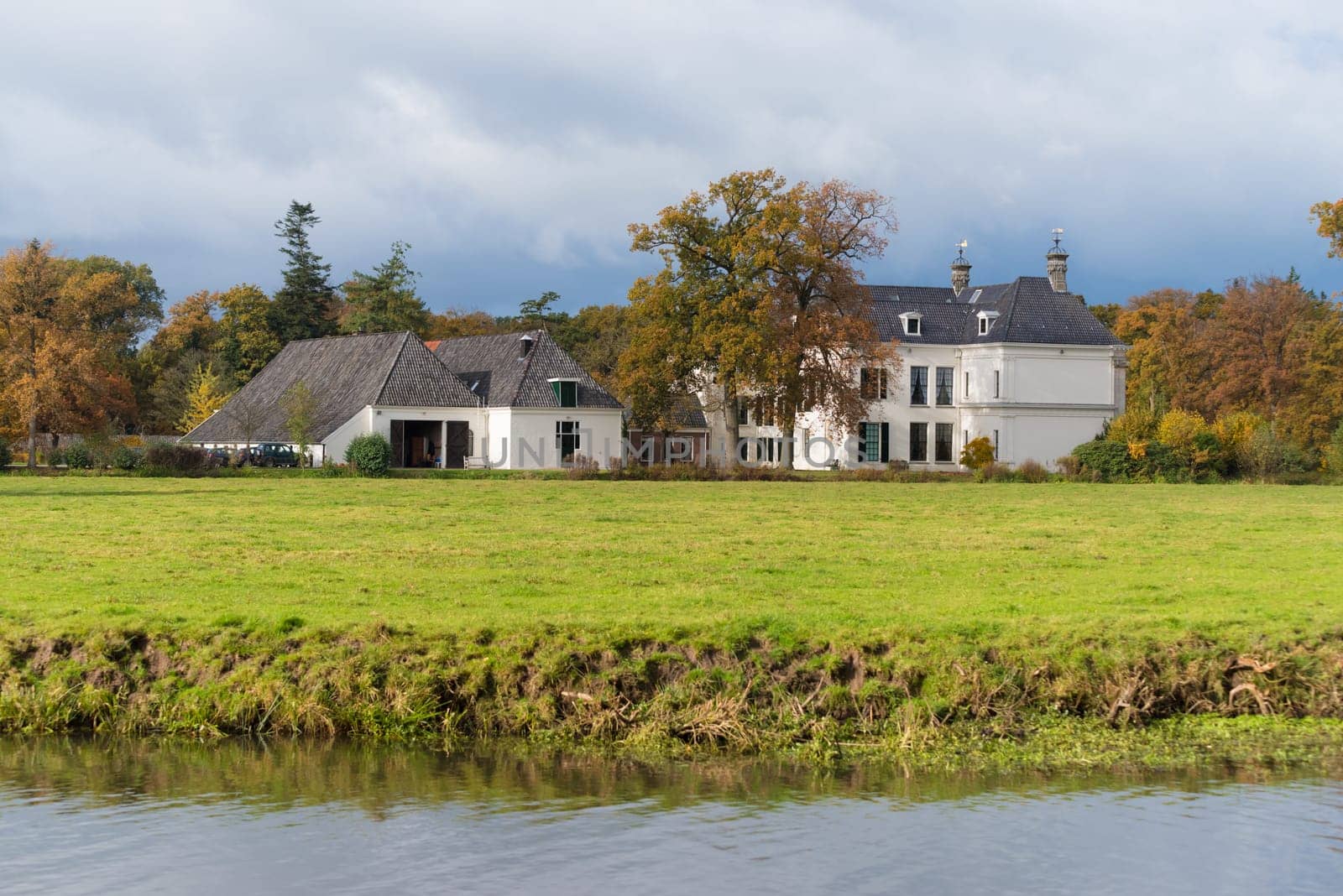 DENEKAMP, NETHERLANDS - NOVEMBER 2, 2016: Singraven mansion with neoclassical frontage in a rural surrounding