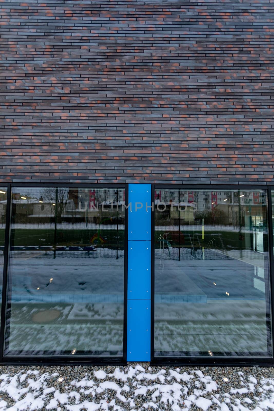 Sleek building exterior showcasing a blend of glass and brick, ideal for contemporary design themes.