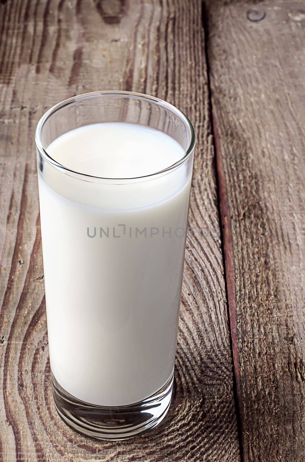 The glass of milk on the old table